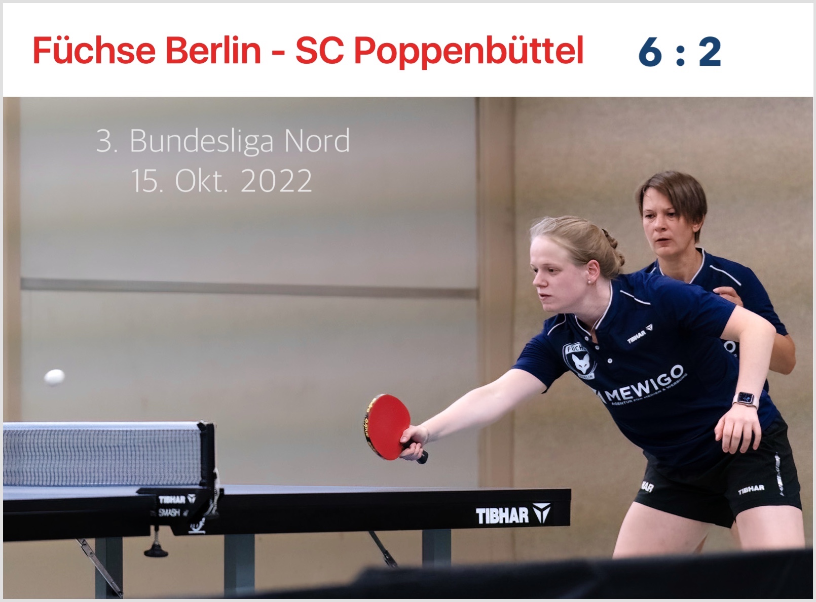 Füchse Berlin gewinnt gegen den SC Poppenbüttel am 15.10.2022 6 zu 2. Auf dem Bild sieht man zwei Frauen an der Tischtennisplatte. Eine von ihnen hat eine Kelle in der Hand und schaut konzentriert dem Ball nach, welcher gerade übers Netz fliegt.